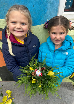 Two children from Year 1 and 2 showing their wreaths